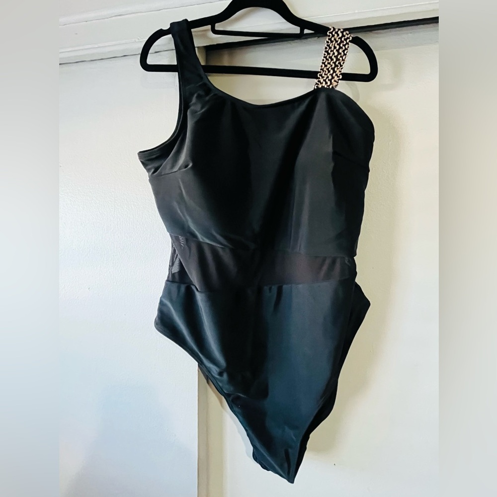 Black One-piece Swimsuit with gold accent on shoulder and sheer midsection.